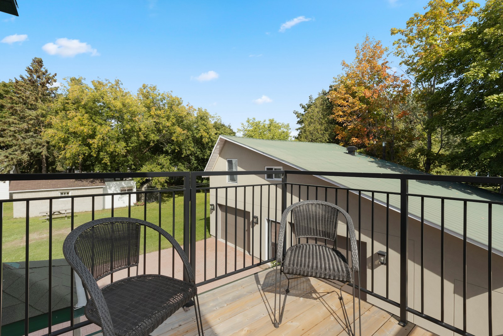 a balcony with two chairs and a table
